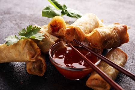 Fried chinese spring rolls with sweet chili sauce on backgroundの写真素材