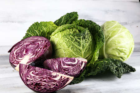 Three fresh organic cabbage heads. Antioxidant balanced diet eating with red cabbage, white cabbage and fresh savoyの写真素材