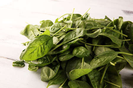 Fresh spinach leaves on rustic wooden table. healthy vegetable leafの写真素材