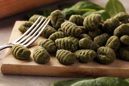 hand made gnocchi with fresh spinach. italian traditional gnocchi on tableの写真素材