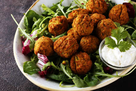 roasted falafel chickpeas patties with garlic yogurt sauce on backgroundの写真素材