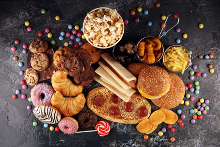 Unhealthy products. food bad for figure, skin, heart and teeth. Assortment of fast carbohydrates food with fries and colaの写真素材