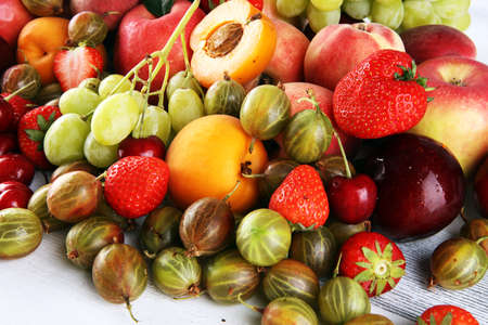 Fresh summer fruits with apple, grapes, berries, plums and organic apricot.の写真素材
