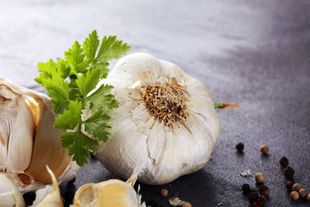 White organic garlic on a rustic table and garlic piecesの写真素材