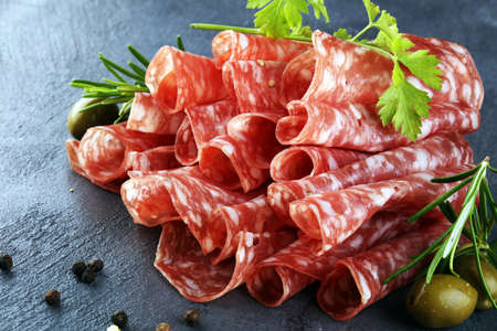 thinly sliced salami. delicious snack rustic salami.の写真素材