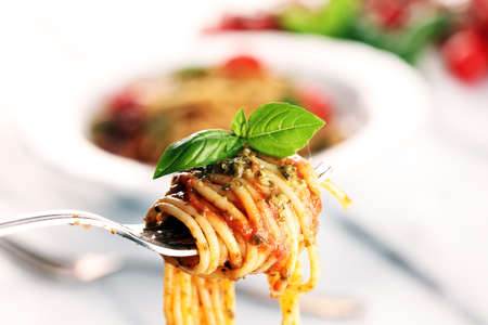 Plate of delicious spaghetti Bolognaise or Bolognese with savory minced beef and tomato sauce garnished with parmesan cheeseの写真素材
