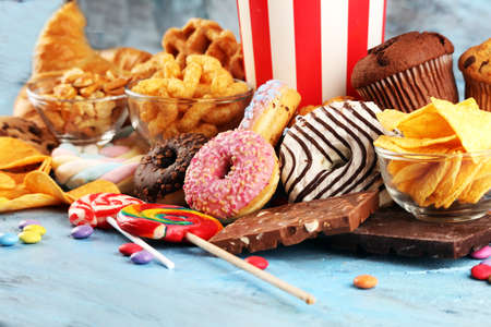 Unhealthy products. food bad for figure, skin, heart and teeth. Assortment of fast carbohydrates food with fries and colaの写真素材