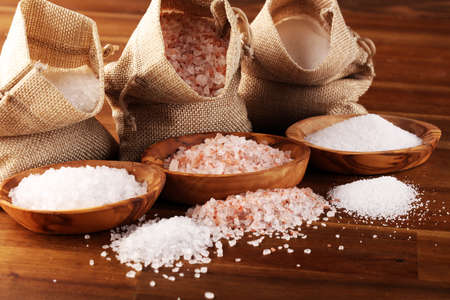 Sea salt and himalayan salt. Crystals of salt on rustic tableの写真素材