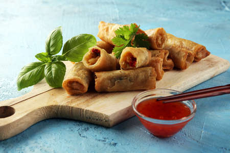 Fried chinese spring rolls with sweet chili sauce on backgroundの写真素材