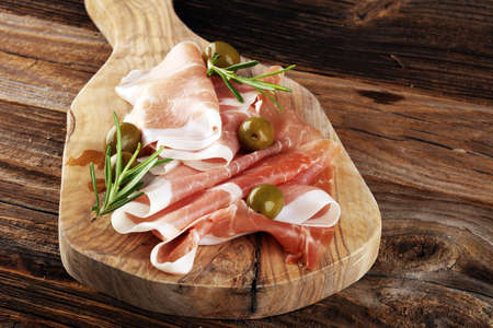 Italian prosciutto crudo or jamon with rosemary. Raw ham appetizerの写真素材