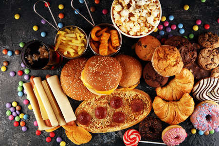 Unhealthy products. food bad for figure, skin, heart and teeth. Assortment of fast carbohydrates food with fries and colaの写真素材