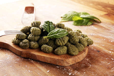 hand made gnocchi with fresh spinach. italian traditional gnocchi on tableの写真素材