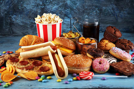Unhealthy products. food bad for figure, skin, heart and teeth. Assortment of fast carbohydrates food with fries and colaの写真素材