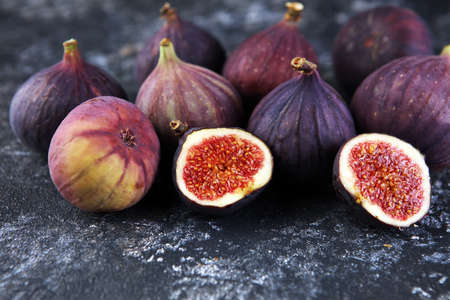Fresh figs. Food Photo. Whole and sliced figs on rustic backgroundの写真素材