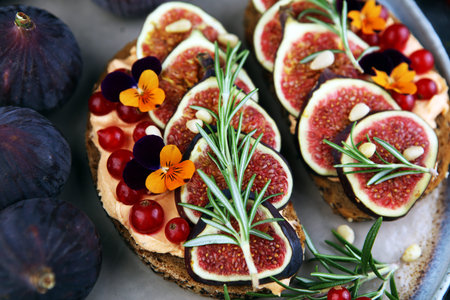 Healthy sweet figs fruit toast with cheese, honey and flower. Fresh fig fruit and flower decoration.