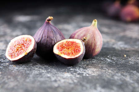 Fresh figs. Food Photo. Whole and sliced figs on rustic backgroundの写真素材