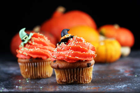 halloween cupcake and pumpkin on a dark background. sweets with cupcakes for the celebrationの写真素材
