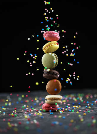 Sweet and colorful french macaroons or macaron on dark backgroundの写真素材