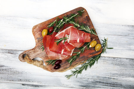 Italian prosciutto crudo or jamon with rosemary. Raw ham appetizerの写真素材