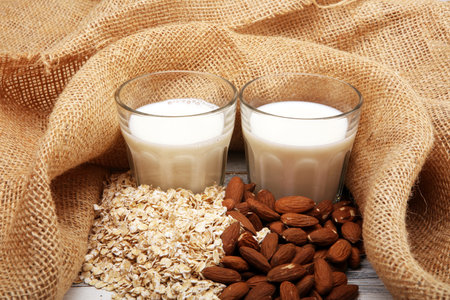 Alternative types of milks. Vegan substitute dairy milk. almond and oatの写真素材