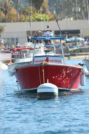 A red harbor partol boat sits at its mooringのeditorial素材