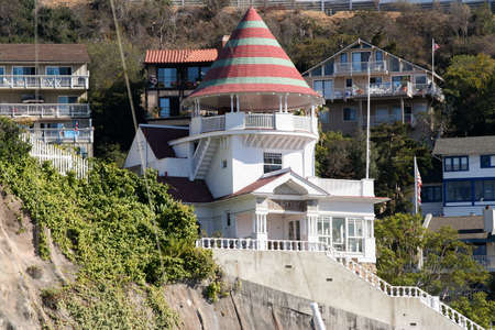 Brightly colorod Holly House in Avalon California, Catalina Island. The Lookout Cottage stands perched on a cliff overlooking Avalon Harbor surrounded by green and vacation cottages.のeditorial素材