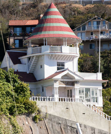 Brightly colorod Holly House in Avalon California, Catalina Island. The Lookout Cottage stands perched on a cliff overlooking Avalon Harbor surrounded by green and vacation cottages.のeditorial素材