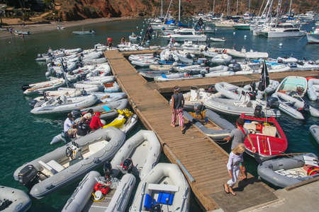 Early on Buccanners Weekend 2009 at the Isthmus, Two Harbors, Catalina Island, California, showing the crowded docks with colorful dinghies and sailboatsのeditorial素材