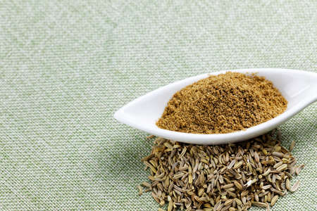 Aromatic fennel powder and seeds on  texture backgroundの写真素材