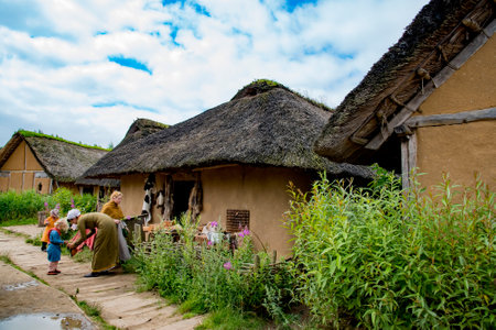 Actors dressed in middle age viking attires and performing daily activities of viking villager in Viking Haithabu village. Taken in Busdorf, Germany on July 15, 2016のeditorial素材