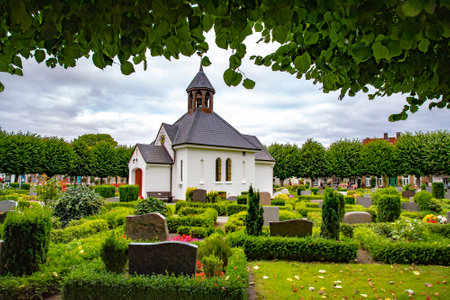 The small chapel and graveyard in Holm, which is an old fishing village, founded around 1000 a.c. at the Schlei, formerly an island now connected to the town of Schleswig. There are picturesque houses and cobbled roads. Taken on July 15,2016のeditorial素材