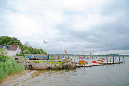 Old wooden jetties in Holm, which is an old fishing village, founded around 1000 a.c. at the Schlei, formerly an island now connected to the town of Schleswig. There are picturesque houses and cobbled roads. Taken on July 15,2016のeditorial素材