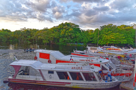 Fishing boats parking at Marina Do Davi along Taruma Acu River at sunset. Taken in Manaus, Brasil on June 3, 2019のeditorial素材