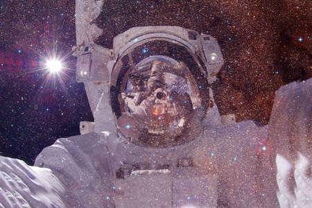Astronaut. Nebula, cluster of stars in deep space. Science fiction art.の写真素材