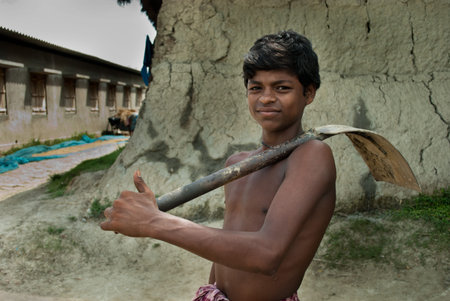 Young Farmer: An Indian young boy with is ready to go to farmland for farming.のeditorial素材