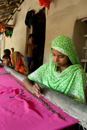 Micro Finance: Two rural Indian women are busy with making hand-knighted garments at outskirts of Kolkata, India.のeditorial素材