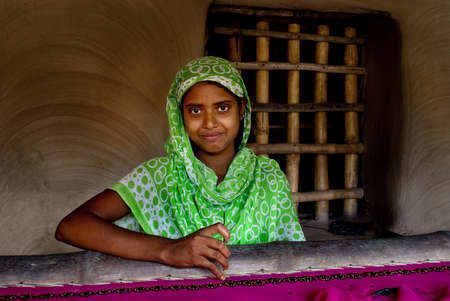 Micro Finance: A rural Indian woman is busy with making hand-knighted garments at outskirts of Kolkata, India.のeditorial素材