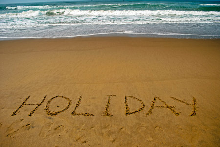 Holiday on sea beach 3:  Holiday ?written on sand of a sea beach. Beach travel concept. Summer holiday.Outdoor.の写真素材
