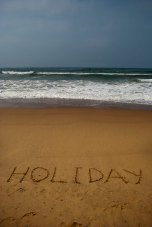 Holiday on sea beach 2: Holiday ?written on sand of a sea beach. Beach travel concept. Summer holiday.Outdoor.の写真素材