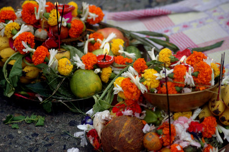 Preparing the offerings to the sun god with various fruits, flowers, candles and...