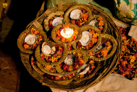 A basket full of floral candles to float as offerings is waiting for religious customers at Varanasi, one of world's oldest living cities, is rightly called the religious capital of India.のeditorial素材