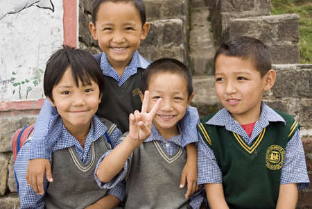 Four Tibetan Children wearing school uniform are playing mood at Tibetan childrens village in Dharamshala, Himachal Pradesh, India.のeditorial素材