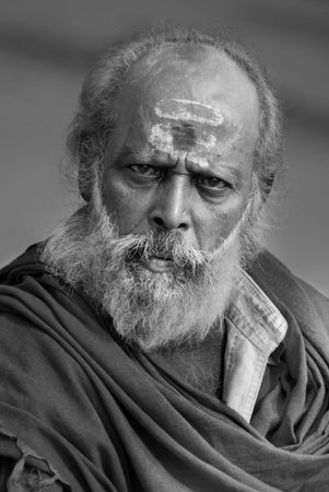 Hindu Monks at Varanasi. Hindu men in religious contemplation on the steps of the Hindu Ghats near the Holy River Ganges in Varanasi in northern India. The river and the city of Varanasi (also known as Benares) are regarded by Hindus as sacred.のeditorial素材