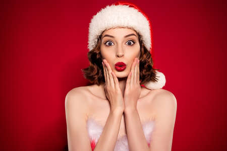 Photo of astonished young fashion model hands cheeks news party cool isolated on dark burgundy gradient backgroundの写真素材