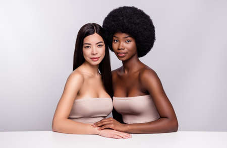 Photo of two young attractive woman happy positive smile cosmetology procedure skincare isolated grey color backgroundの写真素材