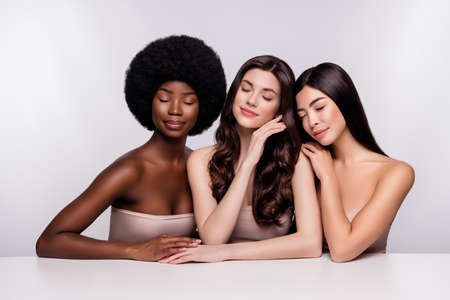 Photo of three young attractive woman dream enjoy sensual perfection bodycare isolated over grey color backgroundの写真素材