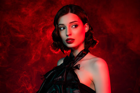 Photo of attractive dreamy woman wear red pomade look empty space imagine isolated on neon fog backgroundの写真素材