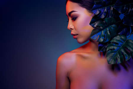 Profile side photo of charming lady green leaves pure beauty empty space isolated glowing bright color backgroundの写真素材