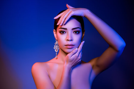 Portrait of feminine vogue lady touch cheeks abstract event prepare isolated gradient vivid colorful backgroundの写真素材