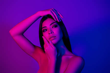 Photo of pretty lady touch hands face look empty space modern beauty procedure isolated vivid colorful backgroundの写真素材